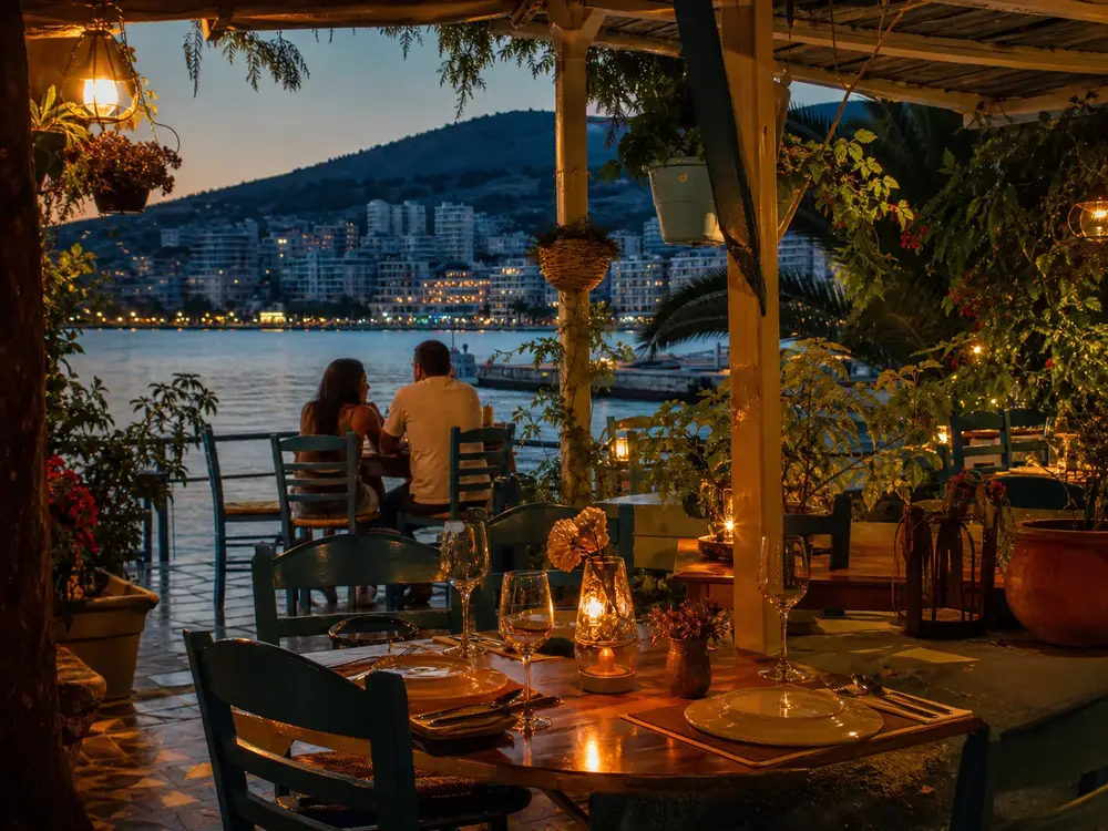 Outdoor dining table set for a seafood dinner at a Ksamil villa