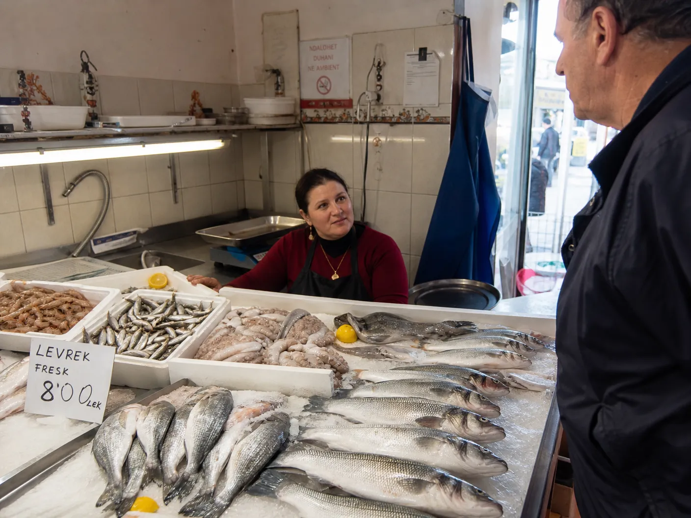 Inside Fish Shop Ardit Saranda — whole sea bream, sea bass and sardines arranged on ice at the daily fish counter